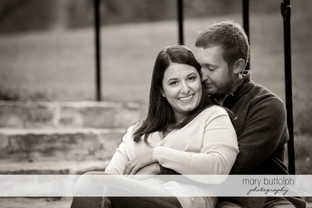 Couple relaxing on a bench in the park at Marcellus Engagement