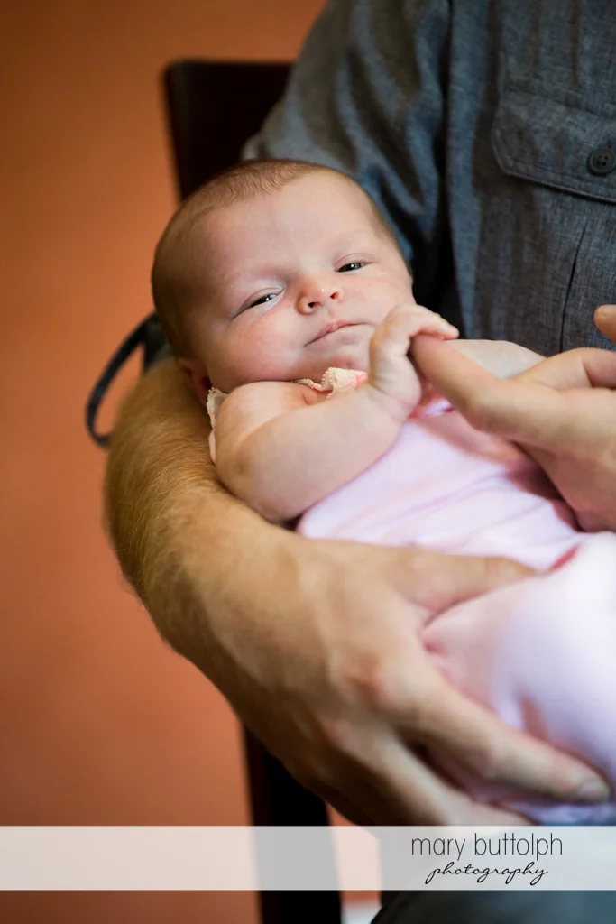 Baby holds daddy's finger at Skaneateles Newborn
