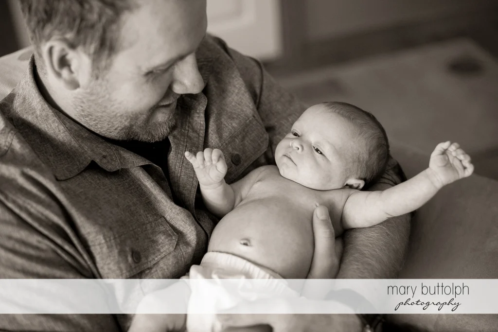 Man carries his baby girl at Skaneateles Newborn