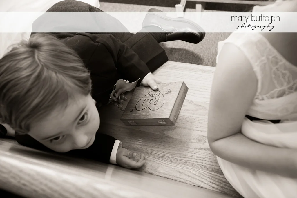 Boy holds a box with the couple's initials at Anyela's Vineyards Wedding