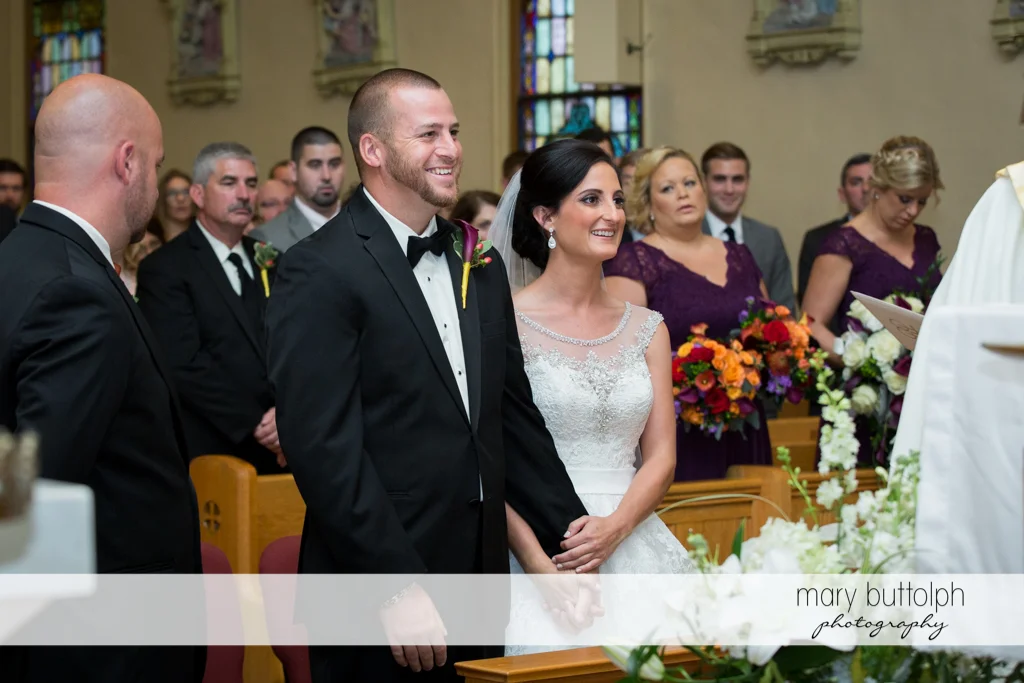 Couple face the priest at Anyela's Vineyards Wedding