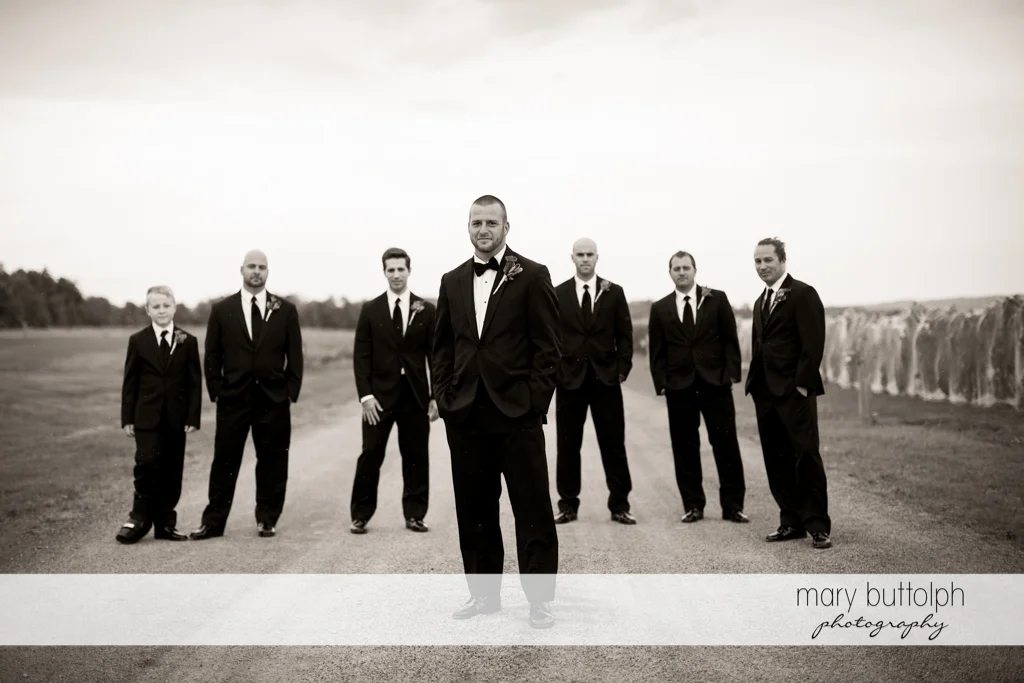 The groom poses with his groomsmen at Anyela's Vineyards Wedding
