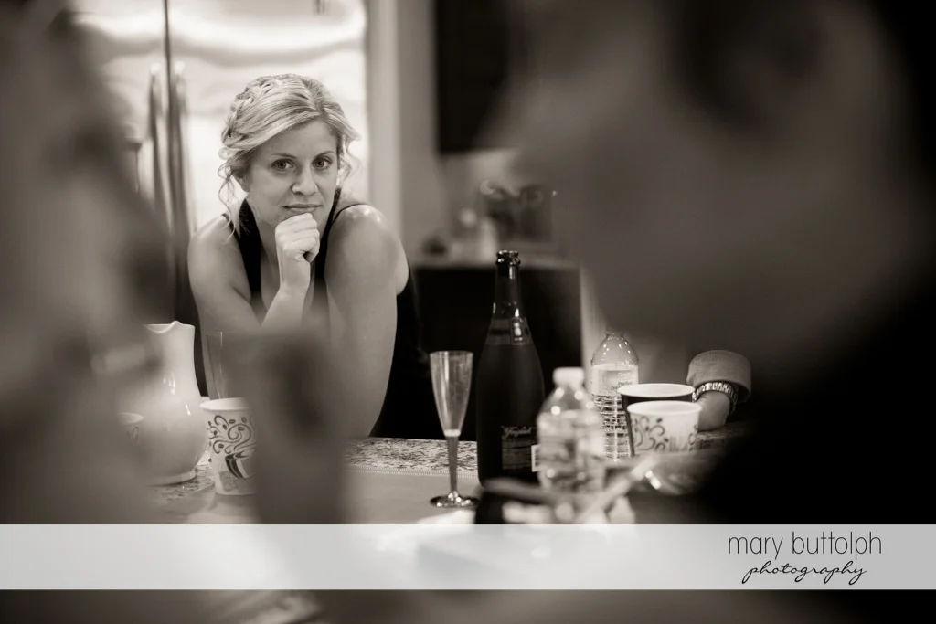 A guest stares at the bride during her makeover session at Anyela's Vineyards Wedding
