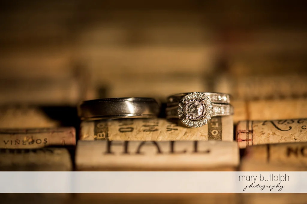 Couple's wedding rings on top of wine corks at Anyela's Vineyards Wedding