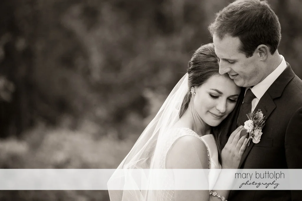 Couple show their affection in the garden at the Frog Pond Bed & Breakfast Wedding