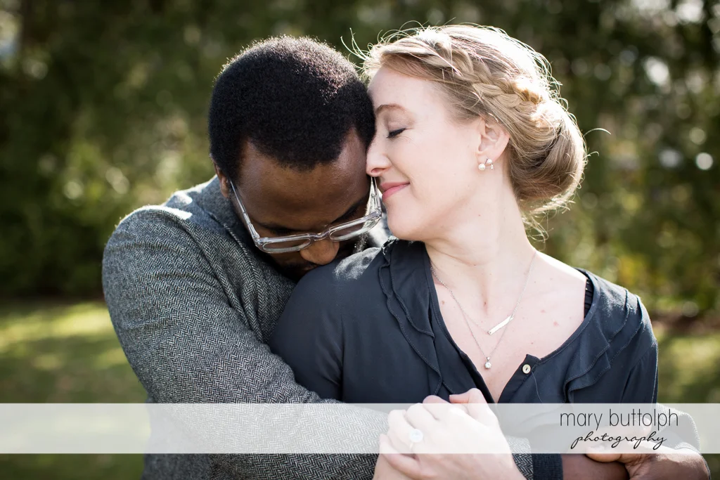 Couple in tight embrace in the park at Skaneateles Engagement