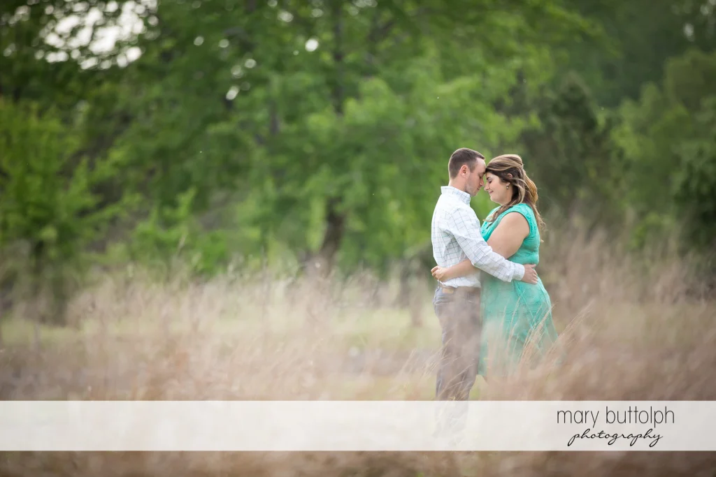Couple hold each other tight in the park at Emerson Park Engagement