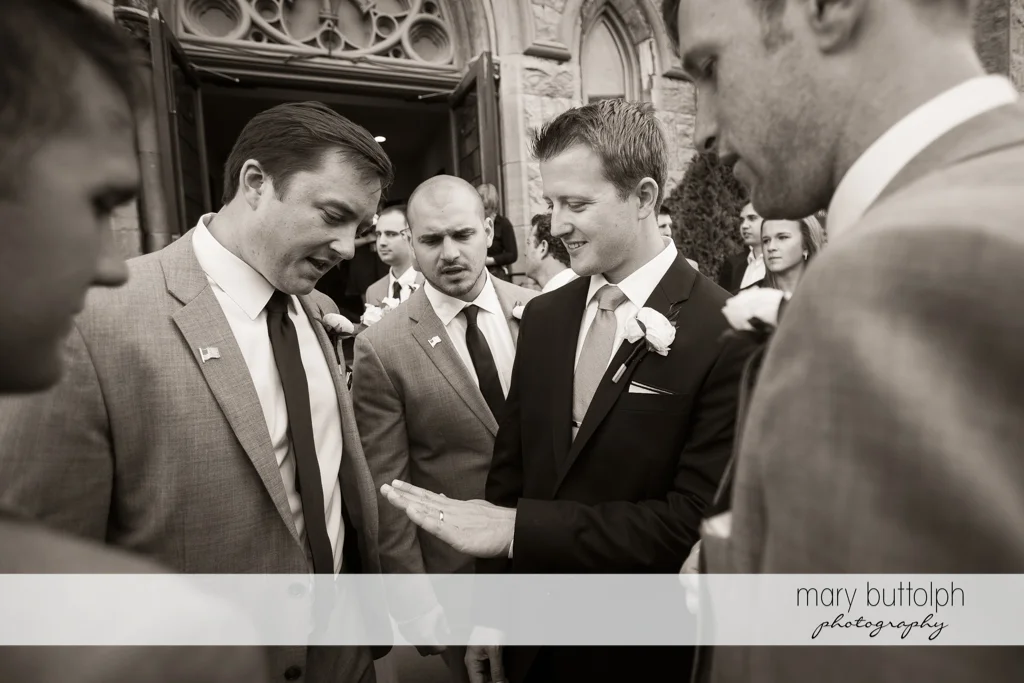 Groom shows his wedding ring to friends at Skaneateles Country Club Wedding