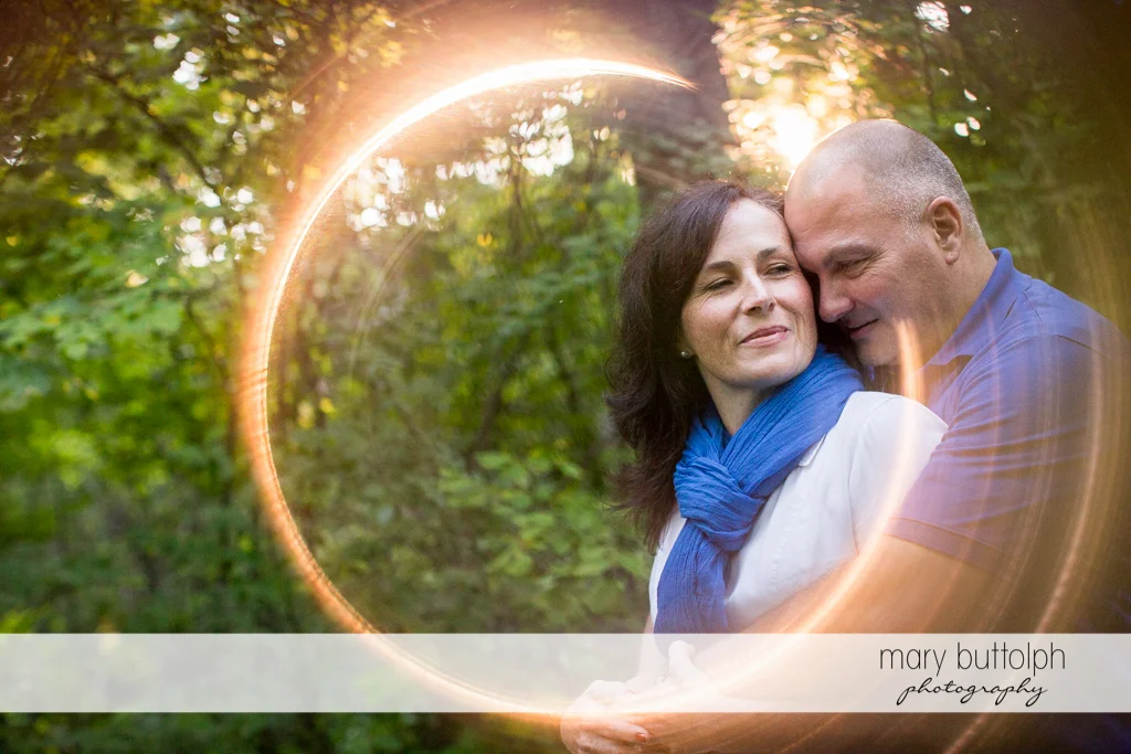 Couple cuddling at the park at Skaneateles Engagement