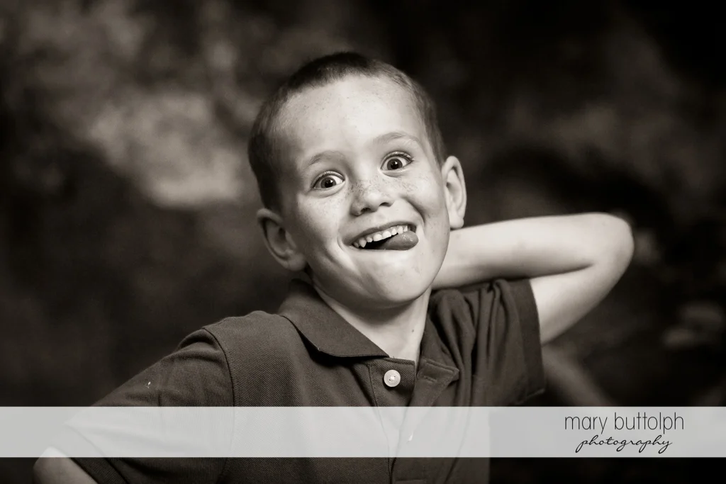 Couple's son makes a funny face while playing in the park at Skaneateles Engagement