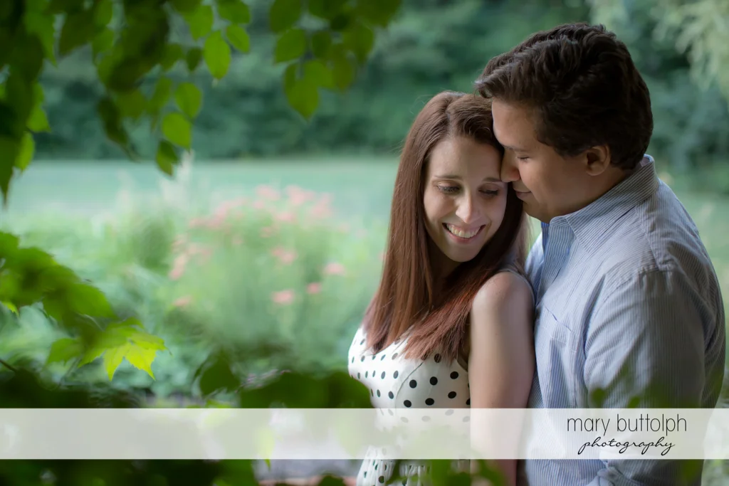 Couple share magical moment in garden at Skaneateles Engagement
