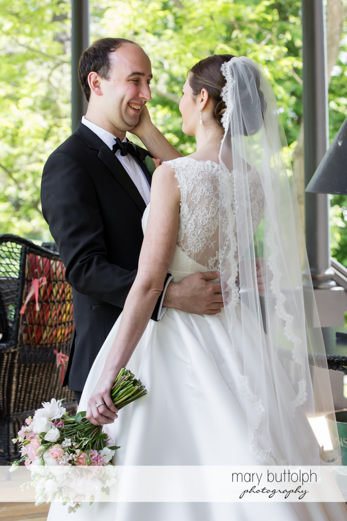 Couple embrace on the porch at the Inns of Aurora Wedding