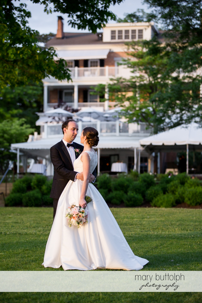 Couple on the lawn in front of one of the structures at the Inns of Aurora Wedding