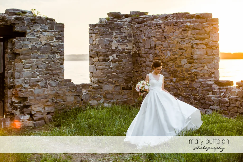 Bride poses in front of one of the ruins at the Inns of Aurora Wedding