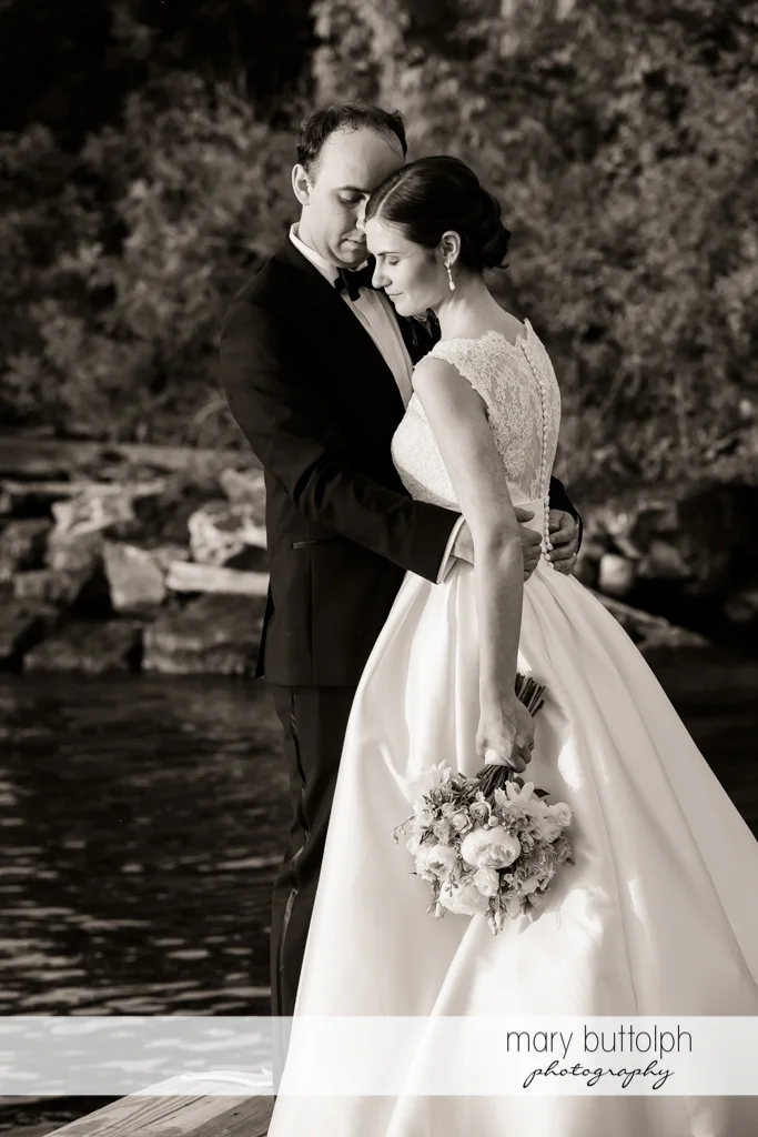 Couple in dramatic black and white shot near the lake at the Inns of Aurora Wedding