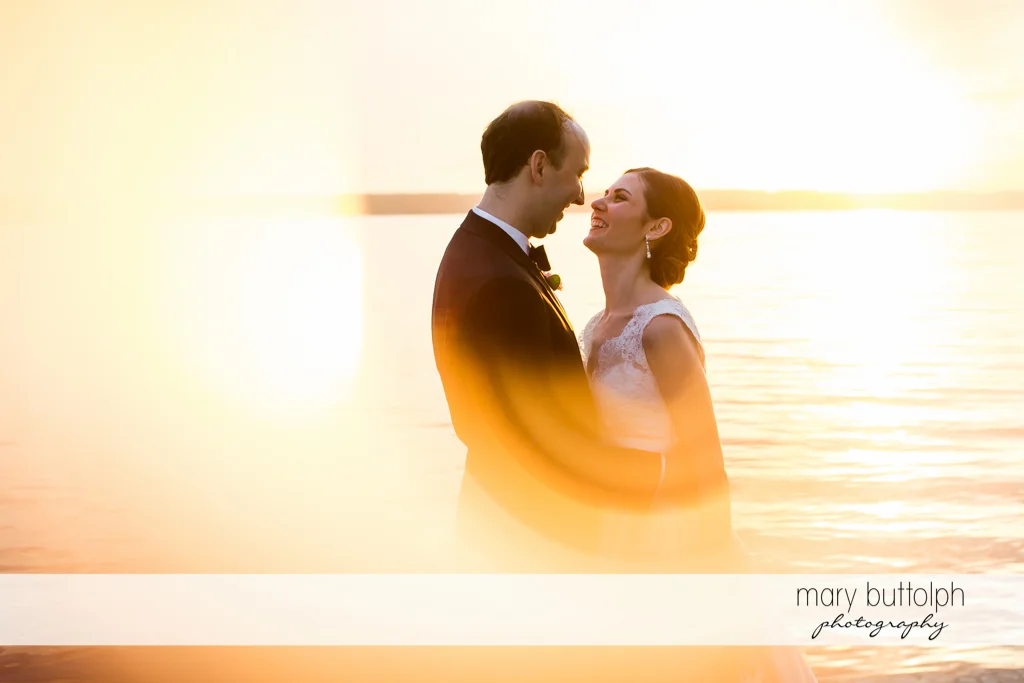 Couple catch the sun's rays near the lake at the Inns of Aurora Wedding