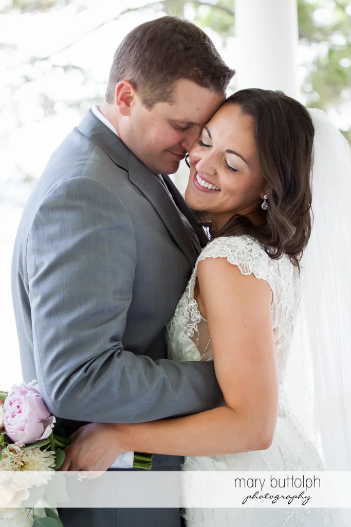 Couple hug for the camera at the Inns of Aurora Wedding