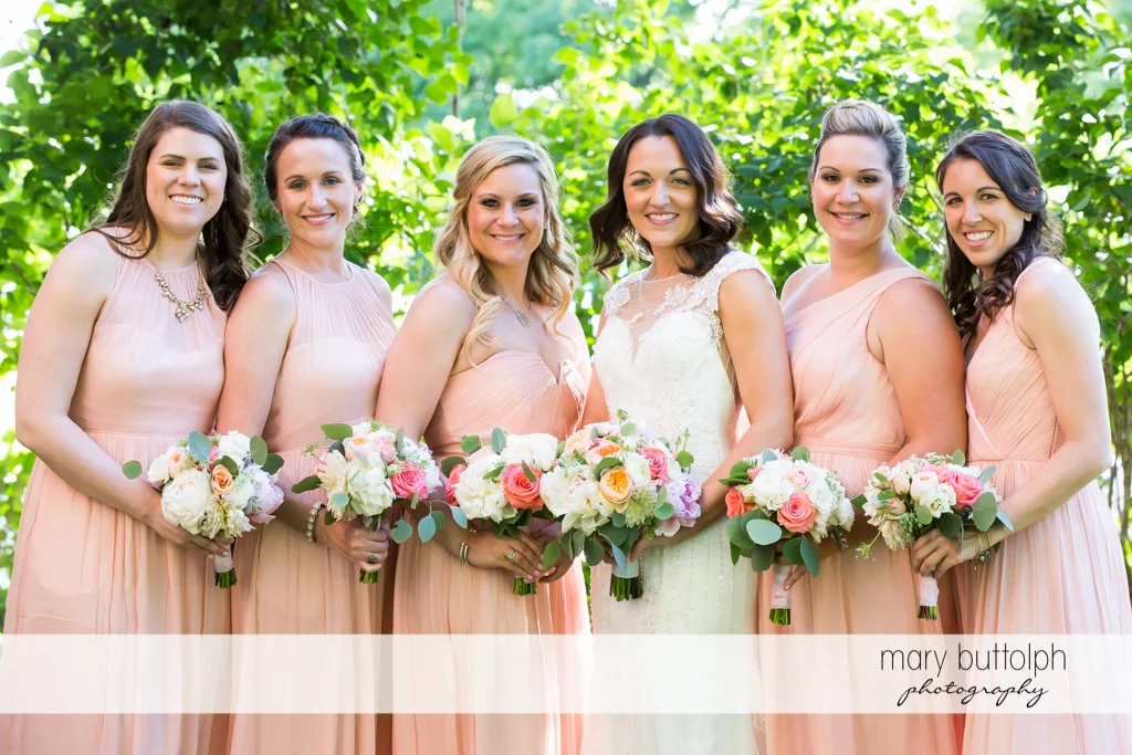 Bride and her bridesmaids in the garden at the Inns of Aurora Wedding