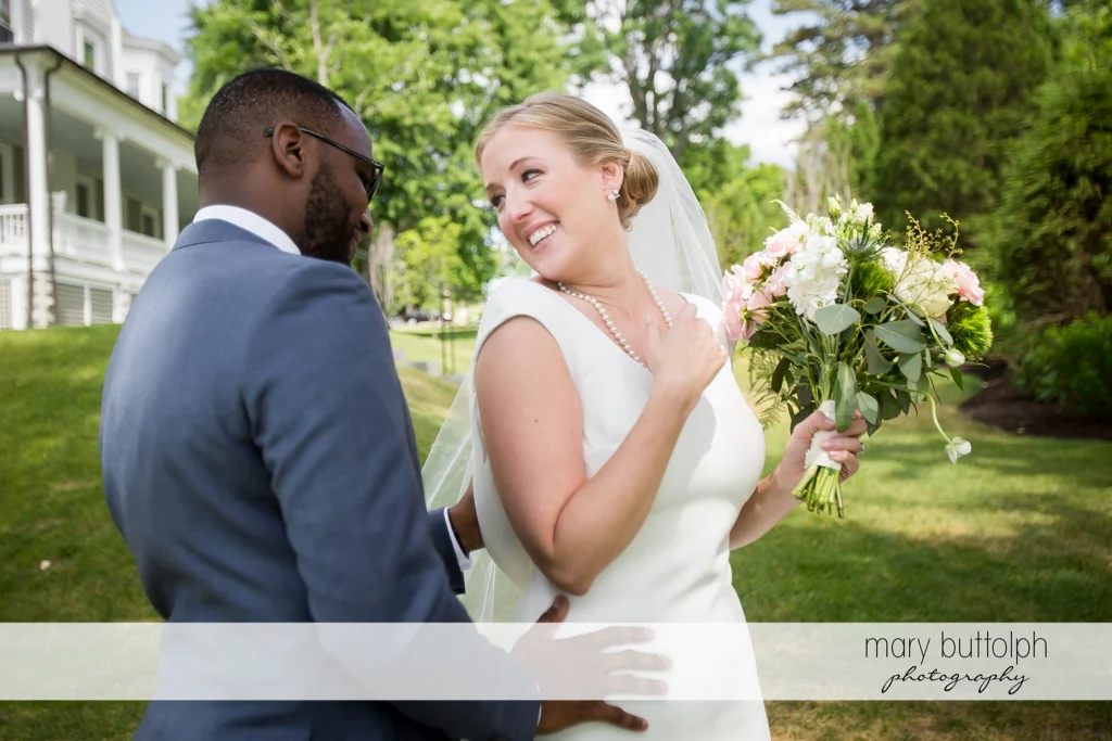 Couple share a light moment in the garden at the Inns of Aurora Wedding