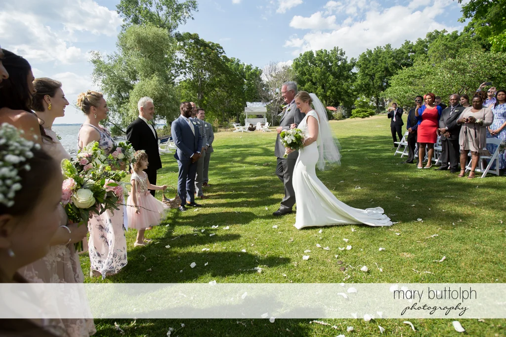Bride and her father approach the groom in the garden at the Inns of Aurora Wedding