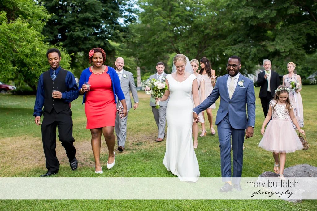 Couple and their family stroll in the garden at the Inns of Aurora Wedding