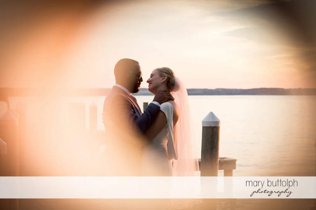 Couple embrace near the lake at the Inns of Aurora Wedding