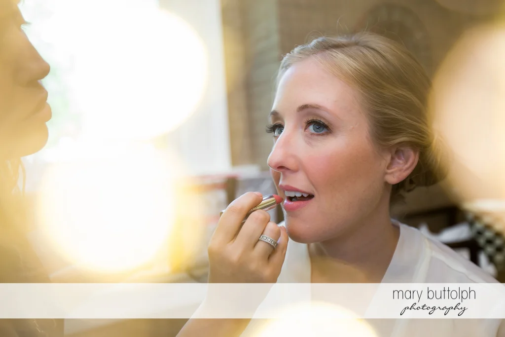 Bride gets some lipstick from a friend at the Inns of Aurora Wedding