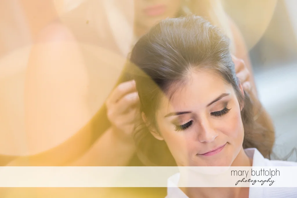 Bride is relaxed as her hair is fixed for her wedding at Genesee Grande Hotel Wedding
