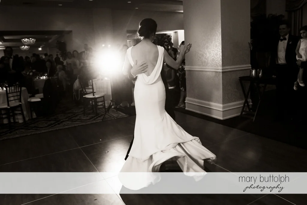 Bride dances with a mystery guest in this trick shot at Genesee Grande Hotel Wedding