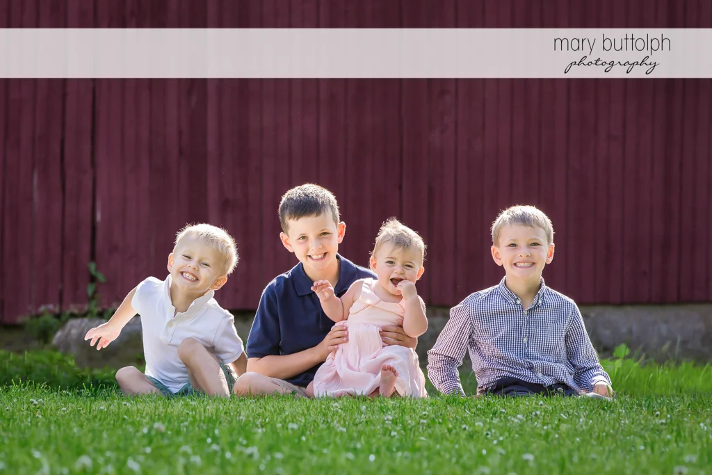 Bothers and their only sister pose in front of their home in the garden at Skaneateles