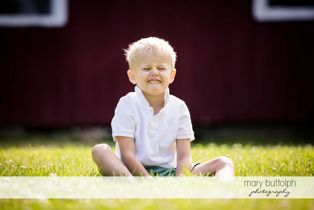 Boy makes a funny face for the camera in front of their home at Skaneateles