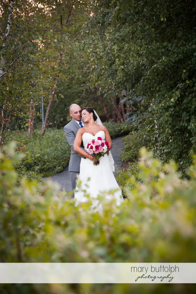 Couple share a quiet moment in the garden at The Lodge at Welch Allyn Wedding