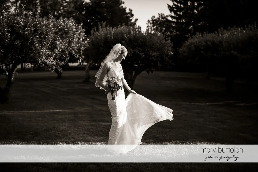 Bride poses in the garden at John Joseph Inn and Elizabeth Restaurant Wedding