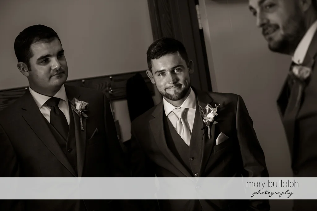 The groom is flanked by the groomsmen at The Lodge at Welch Allyn Wedding