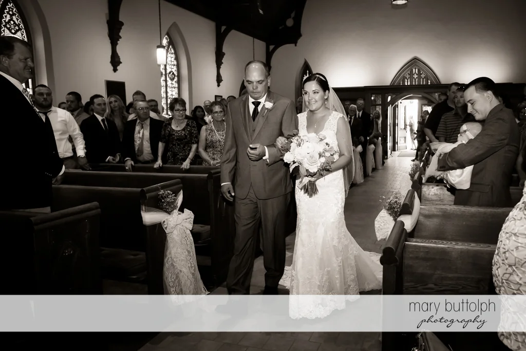 Bride and her father walk down the aisle at The Lodge at Welch Allyn Wedding