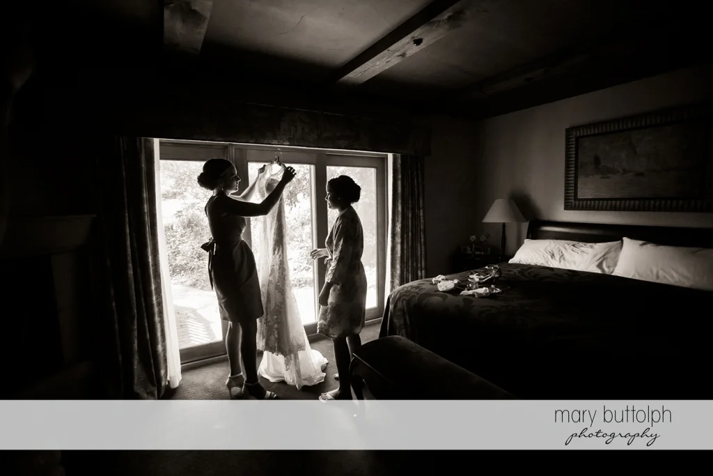 Bride prepares to wear her wedding dress at The Lodge at Welch Allyn Wedding