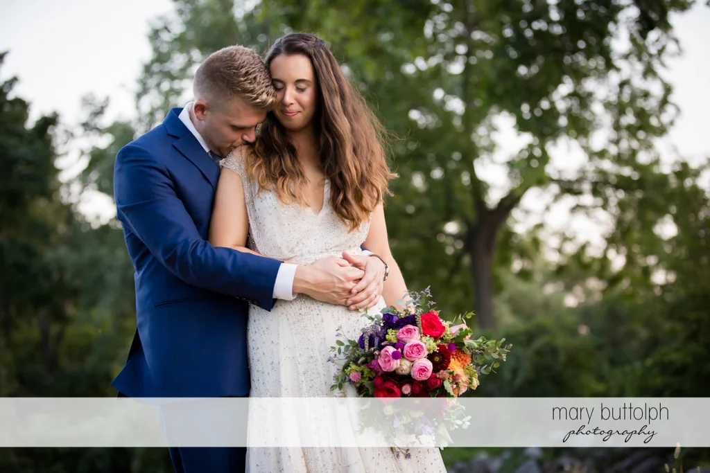 Couple share a quiet moment in the garden at Aurora Inn Wedding