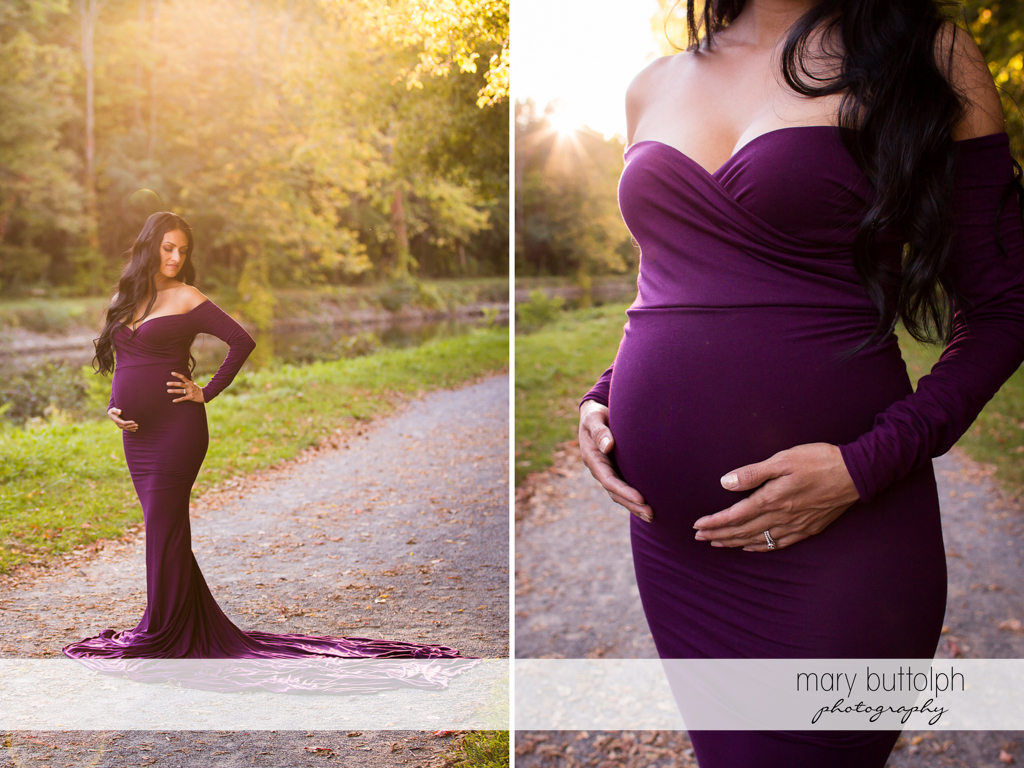 Woman wearing a gown proudly shows her baby bump on the road at Skaneateles Maternity Photography