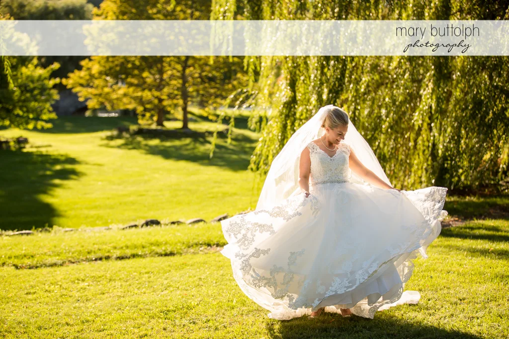 Bride displays her wedding dress in the park at SKY Armory Wedding