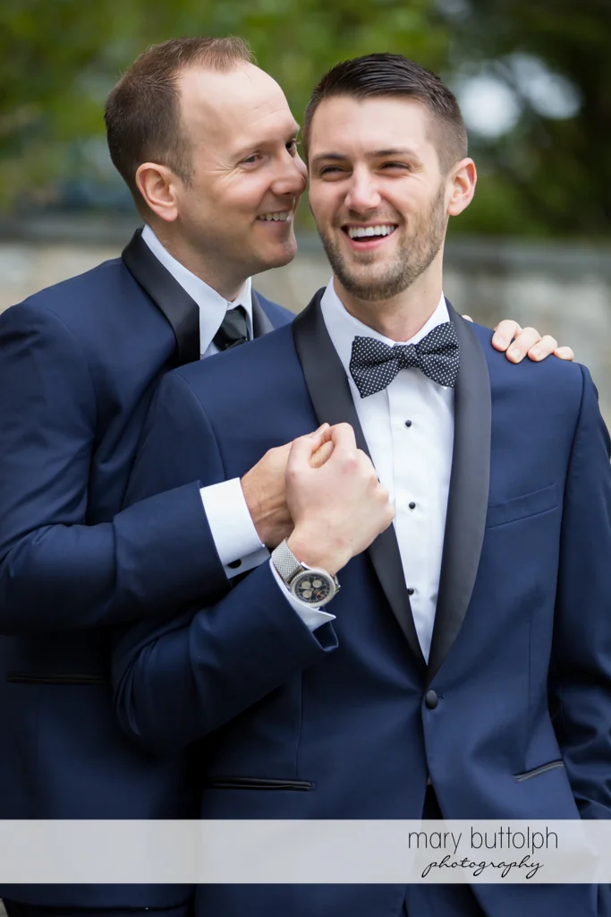 Same sex couple share a light moment at Anyela's Vineyards Wedding