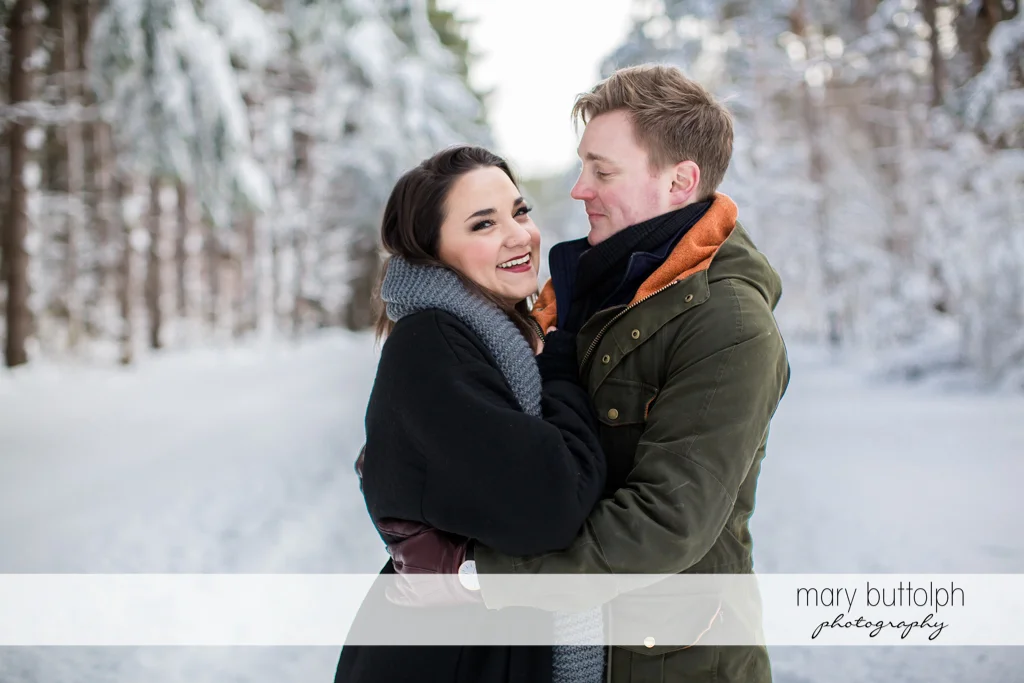 Couple's warm embrace at Highland Forest Engagement