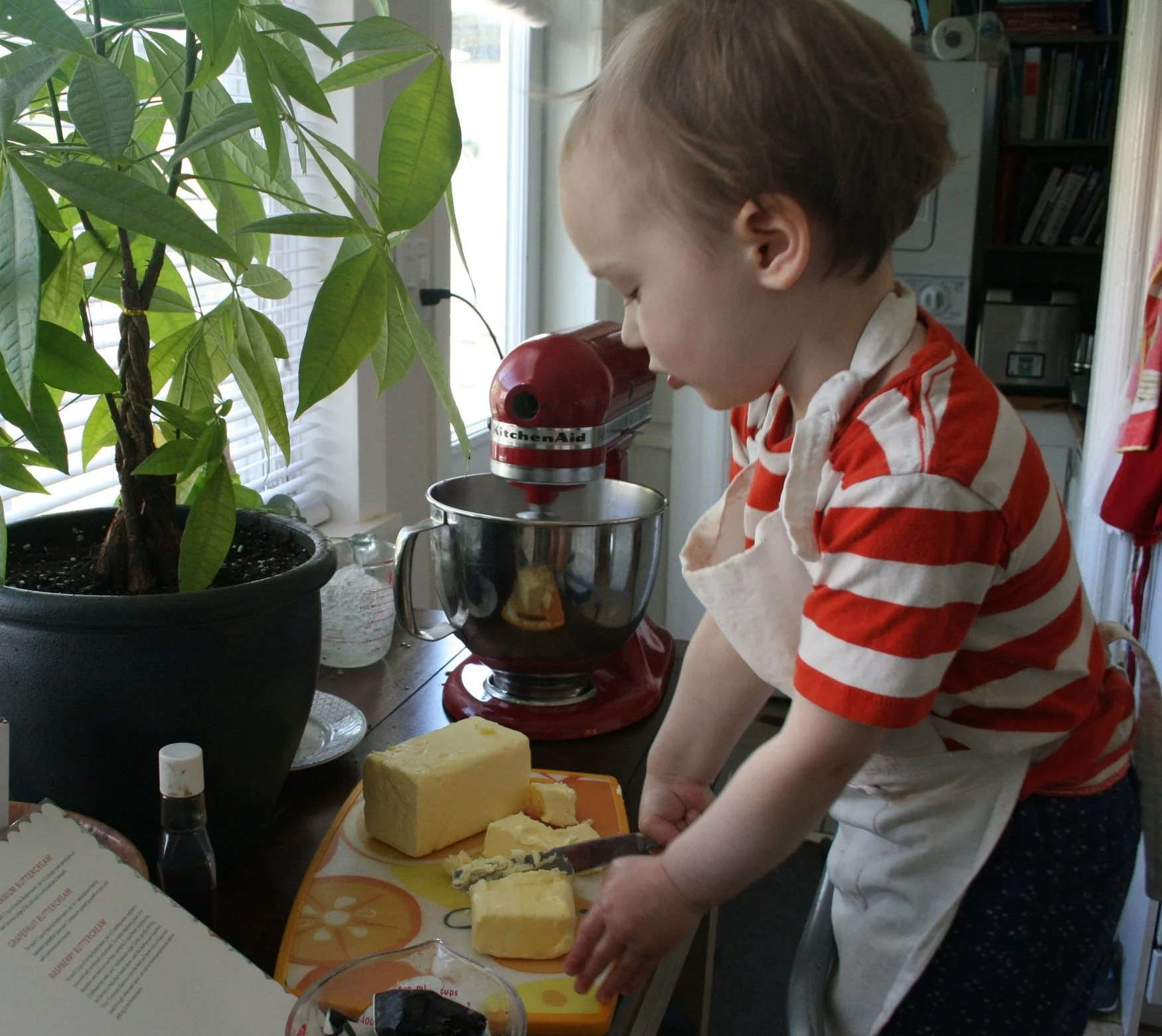 Almost-3-year-old Cash cutting the butter for his buttercream. Yes, all the butter you see goes in the recipe!