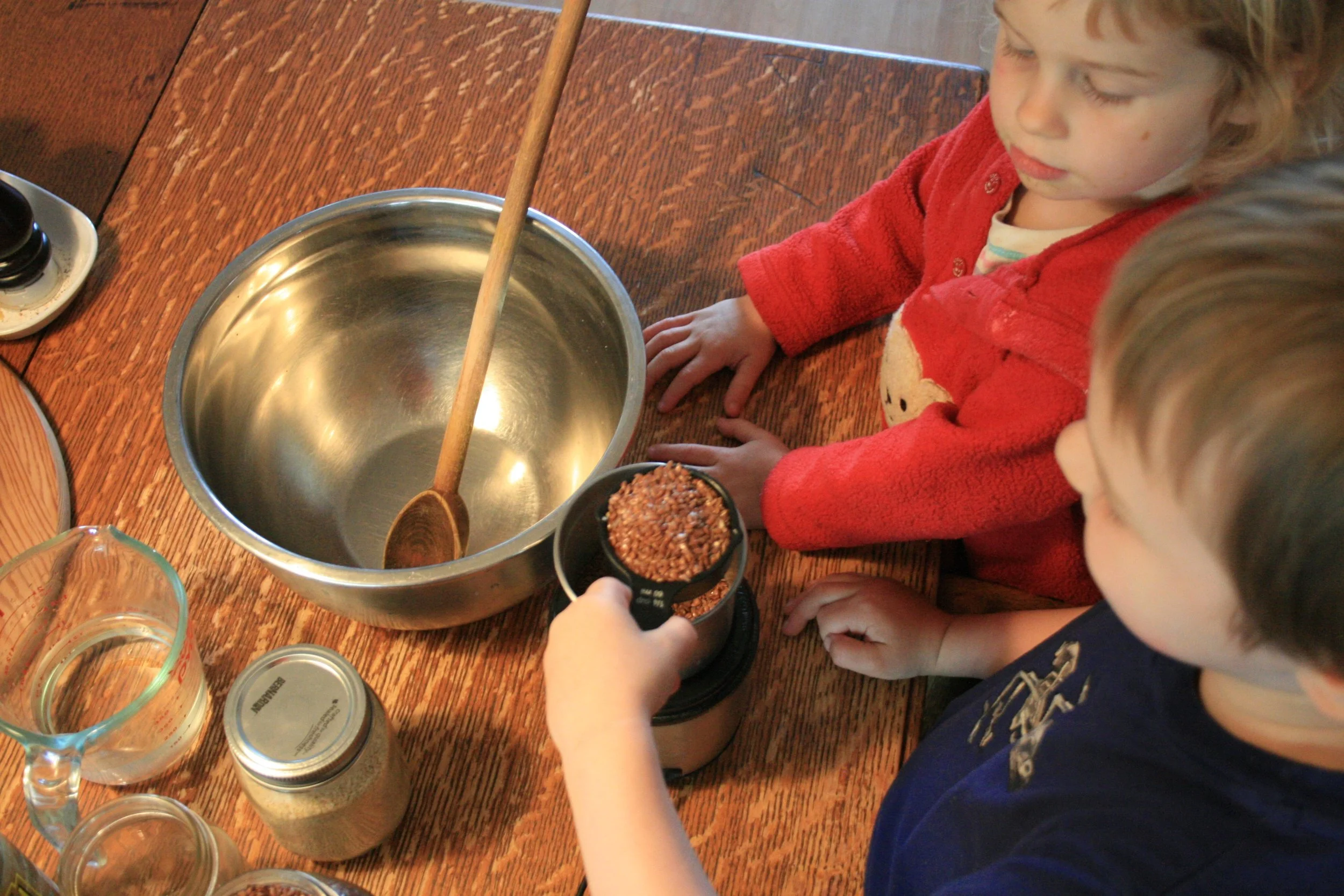 Adding whole flax seeds to the spice grinder to make ground flax, which is what binds the crackers together