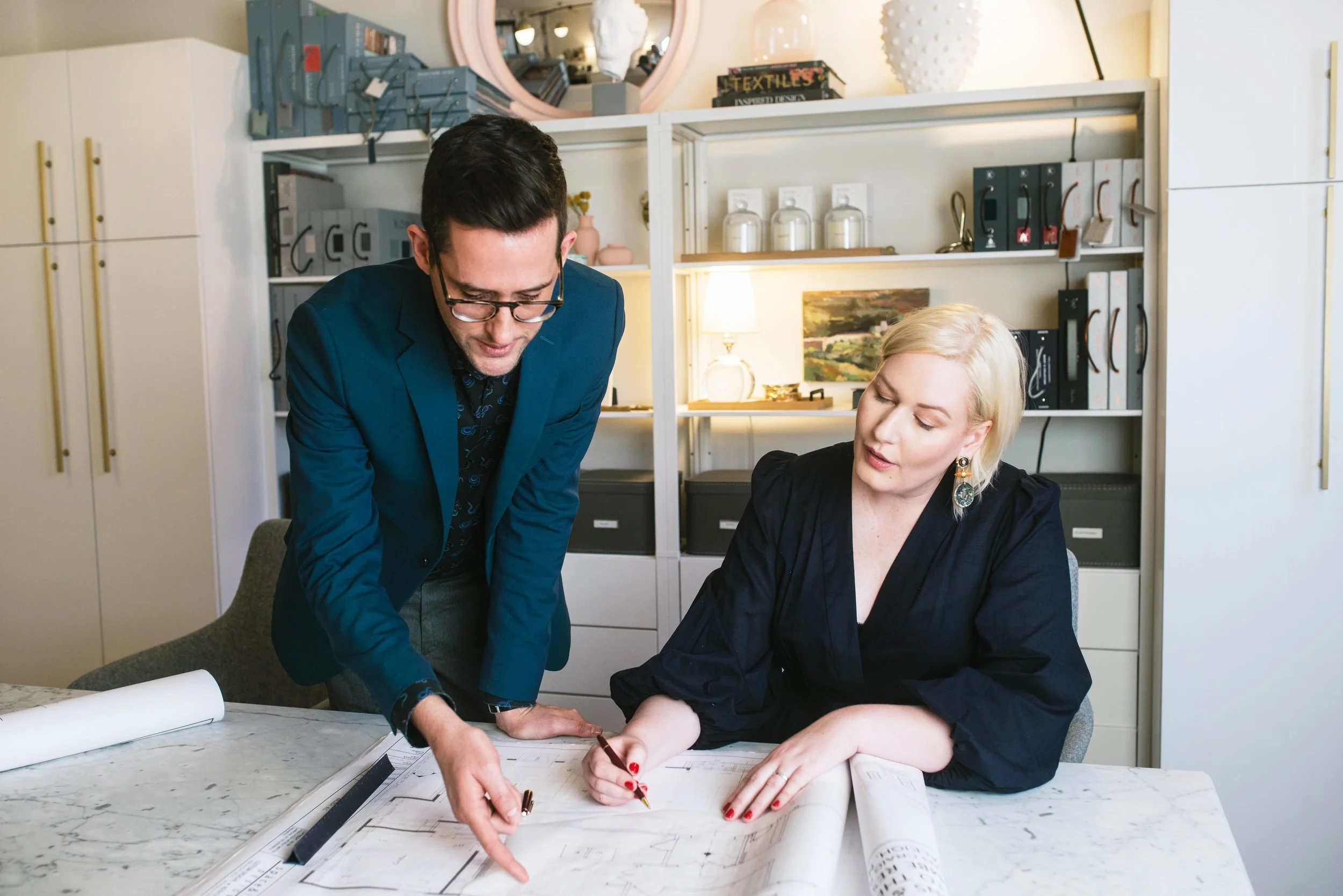 Rob and Brittany looking at plans