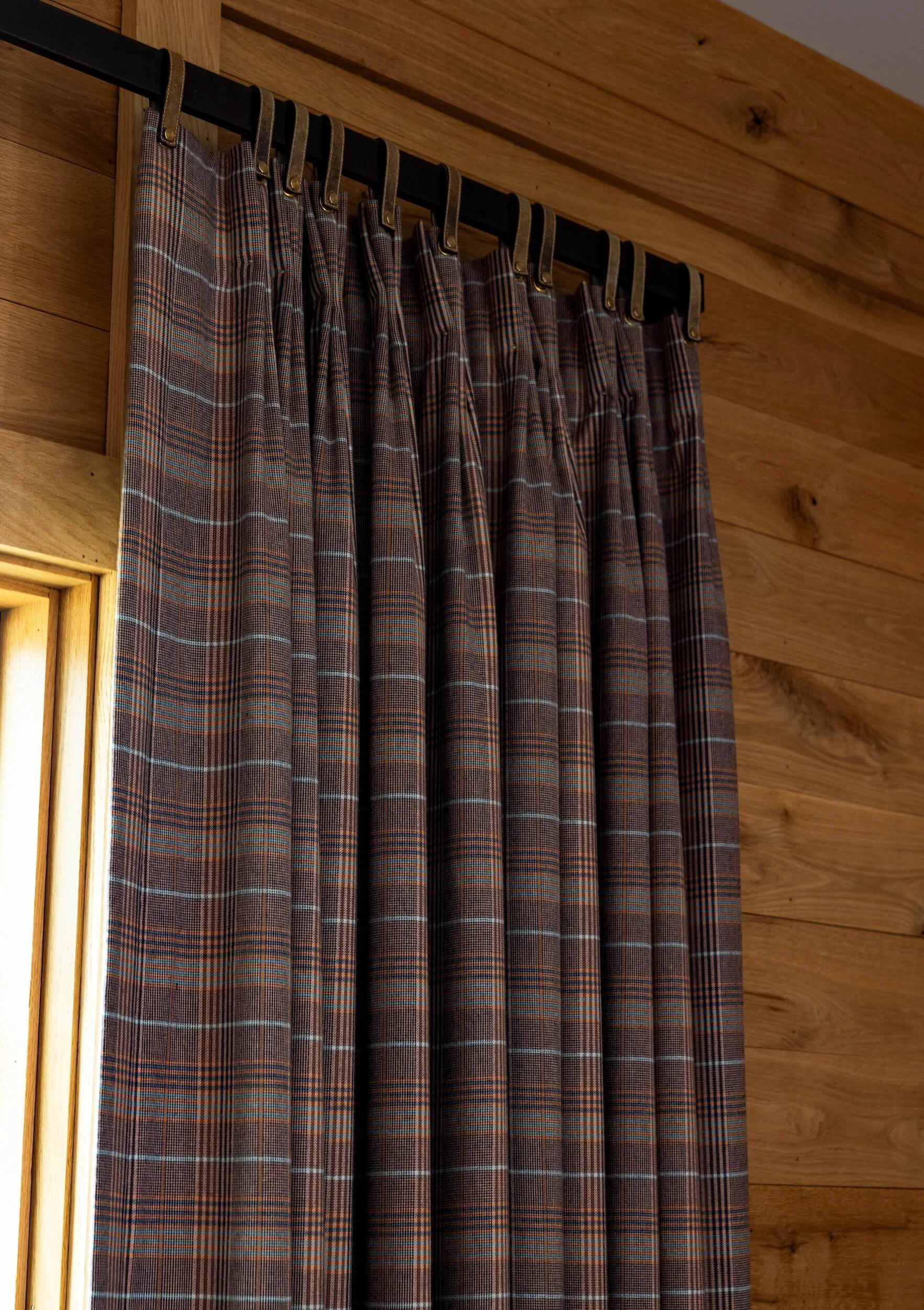 A close up of the custom curtains in the paneled sitting room