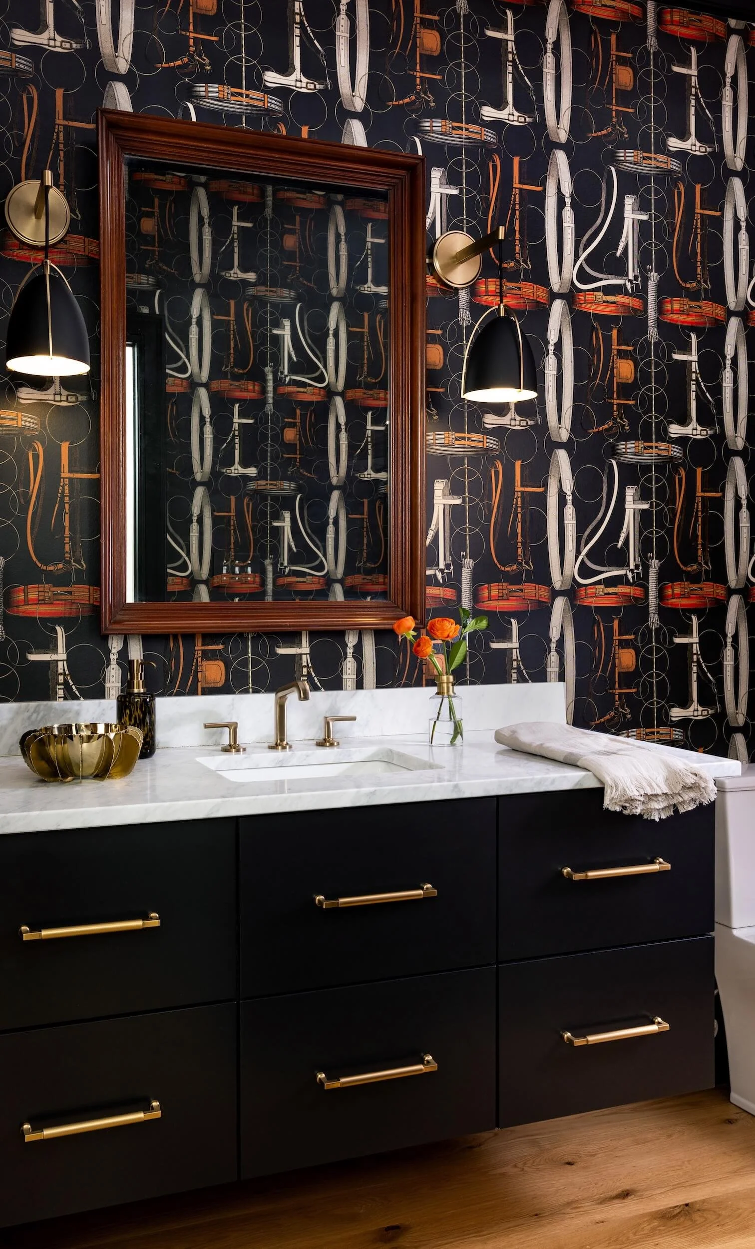 Stunning dark bathroom vanity with custom wallpaper, mirror, and sconces