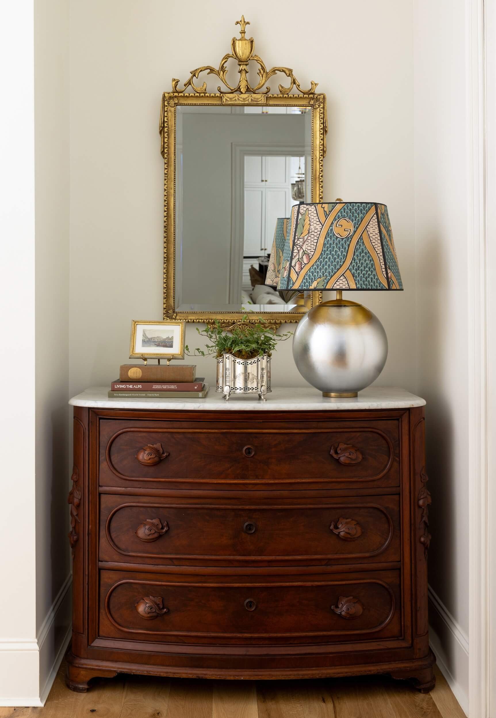 A beautiful three drawer dresser set into a niche in the wall