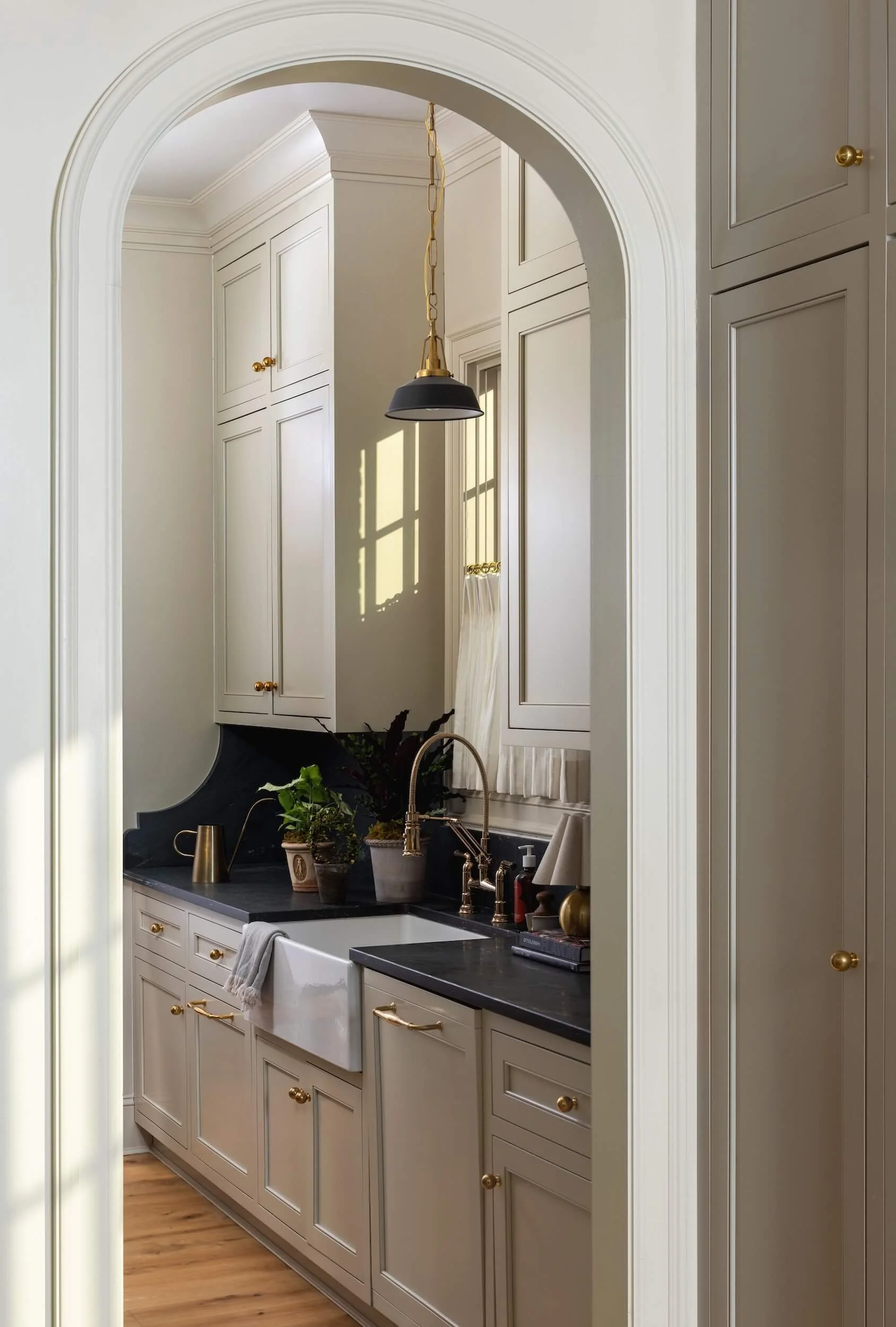 A view through an arched doorway of the scullery 