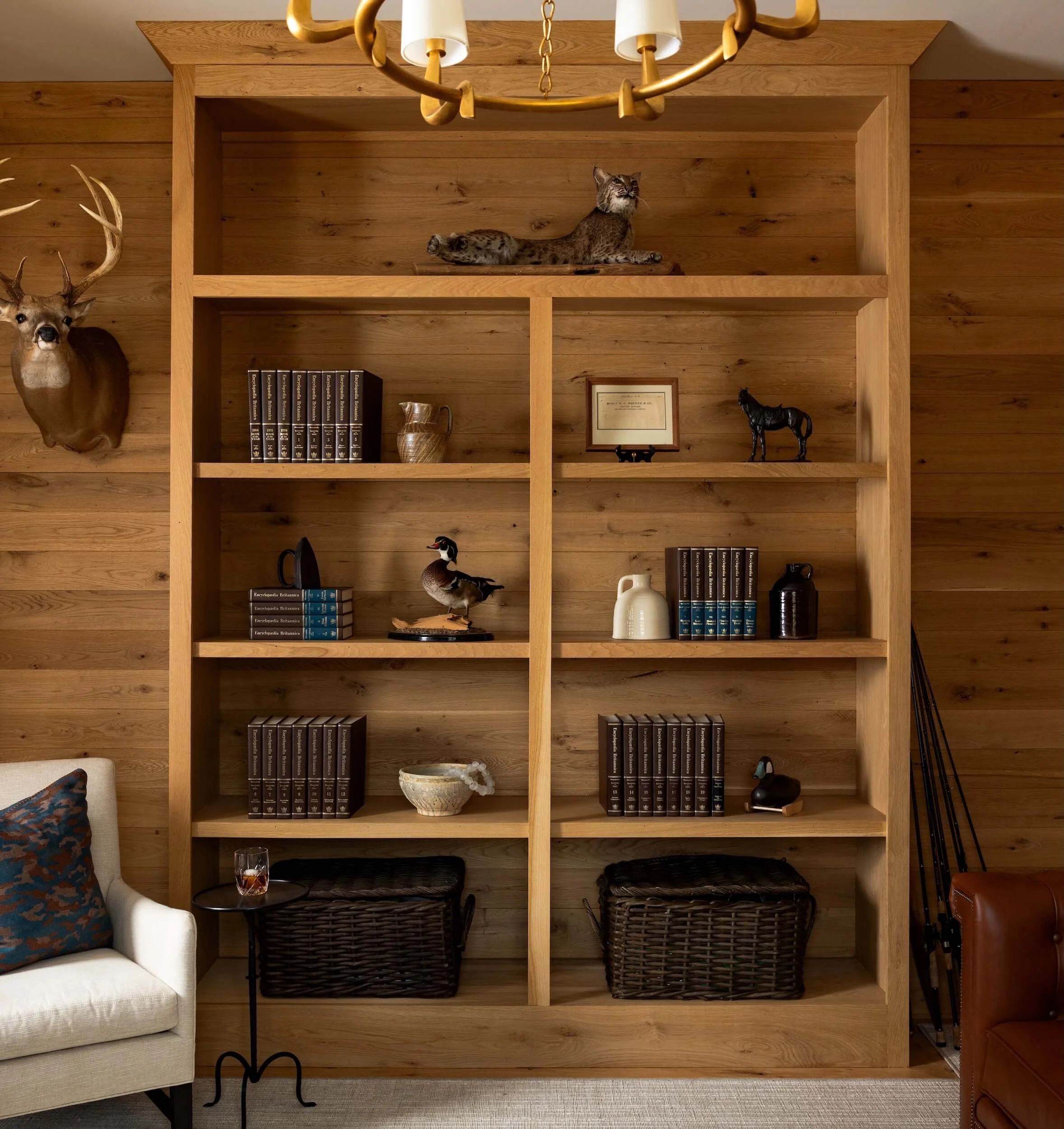 A close up of the wooden bookshelf that seamlessly blends into the paneled walls 