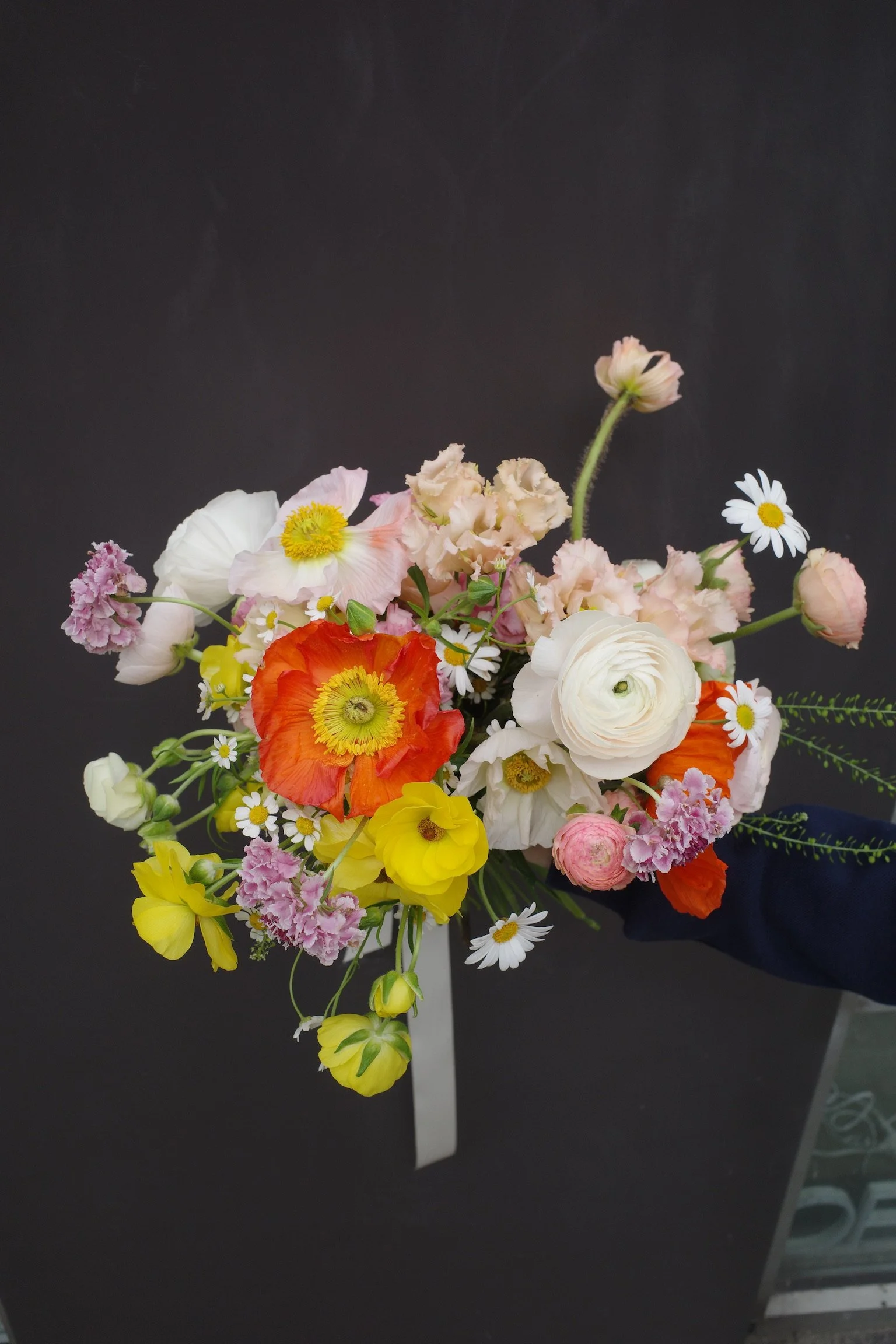 colorful poppy, ranunculus, and lisianthus bouquet